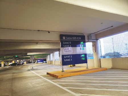 A parking garage sign showing the number of open spaces on each level